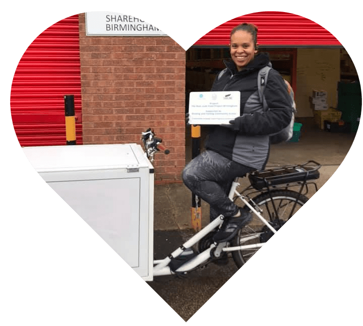 Heart showing a volunteer riding a cargo trike