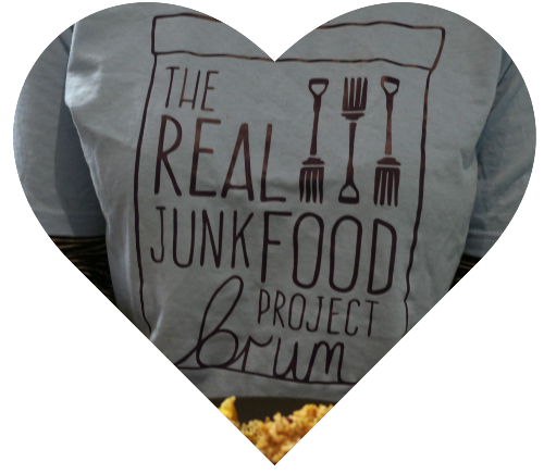 Heart shape enclosing a person wearing a TRJFP Brum t-shirt serving food