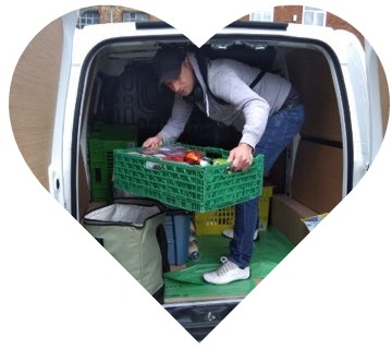 Volunteer taking a crate out of the van